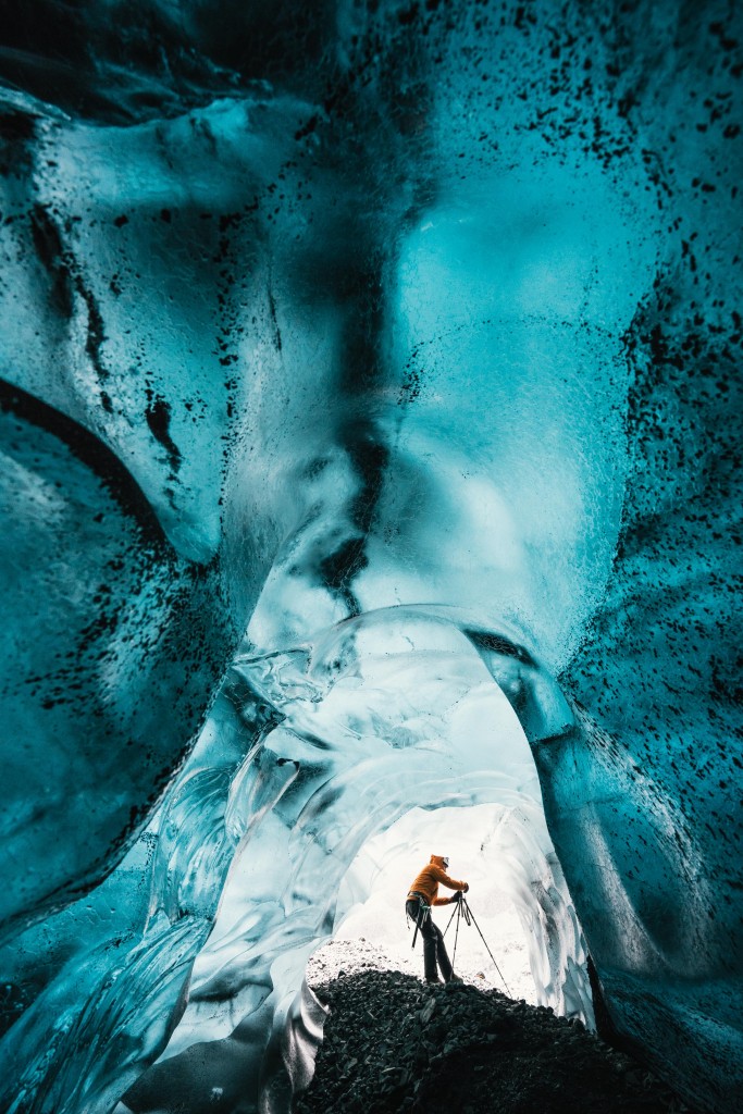 Wednesday 25th November 2015, Vatnajökull national park, Iceland: Photographer Mikael Buck with assistance from renowned local Icelandic guide Einar Runar Sigurdsson, explored the frozen world of Vatnajökull glacier in Iceland using Sonys world first back-illuminated full-frame sensor  which features in the ?7R II camera. His images were taken without use of a tripod or any image stitching techniques in photoshop. This was made possible through Sonys new sensor technology, allowing incredibly detailed low-light hand held photography. Previously images this detailed would have required carrying bulky equipment to the caves, some of which can require hiking and climbing over a glacier for up to two hours to to access. This picture: Inside the 'ABC cave' - which stands for Amazing Blue Cave. Guide Einar Runar Sigurdsson is seen taking a photo at the entrance to the cave PR Handout - editorial usage only. Photographer's details not to be removed from metadata or byline. For further information please contact Rochelle Collison at Hope & Glory PR on 020 7014 5306 or rochelle.collison@hopeandglorypr.com Copyright: © Mikael Buck / Sony 07828 201 042 / mikaelbuck@gmail.com