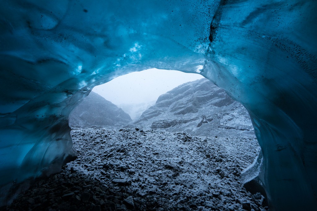 Wednesday 25th November 2015, Vatnajökull national park, Iceland: Photographer Mikael Buck with assistance from renowned local Icelandic guide Einar Runar Sigurdsson, explored the frozen world of Vatnajökull glacier in Iceland using Sonys world first back-illuminated full-frame sensor  which features in the ?7R II camera. His images were taken without use of a tripod or any image stitching techniques in photoshop. This was made possible through Sonys new sensor technology, allowing incredibly detailed low-light hand held photography. Previously images this detailed would have required carrying bulky equipment to the caves, some of which can require hiking and climbing over a glacier for up to two hours to to access. This picture: Inside the 'ABC cave' - which stands for Amazing Blue Cave. This view shows a snow storm outside the entrance to the cave. PR Handout - editorial usage only. Photographer's details not to be removed from metadata or byline. For further information please contact Rochelle Collison at Hope & Glory PR on 020 7014 5306 or rochelle.collison@hopeandglorypr.com Copyright: © Mikael Buck / Sony 07828 201 042 / mikaelbuck@gmail.com